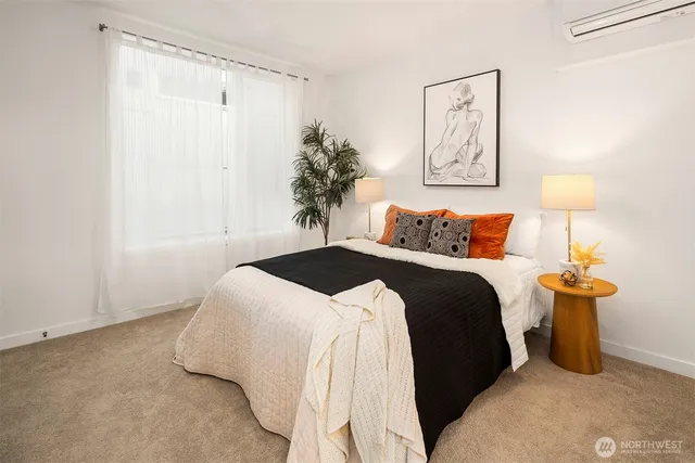 a bedroom with a bed and a potted plant