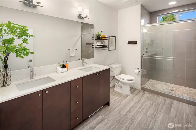 a bathroom with a sink a mirror and a shower