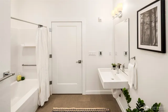 a view of a hallway with wooden floor and entryway