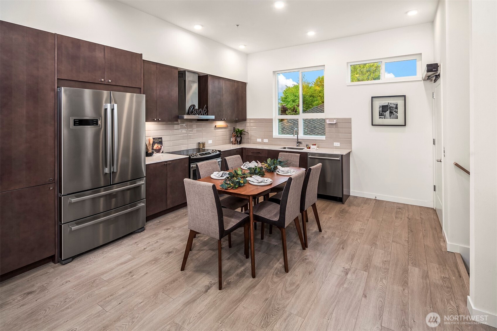 1494 Northwest 75th Street Seattle, WA 98117 - Photo 10 of 22 a kitchen with a table chairs refrigerator and microwave