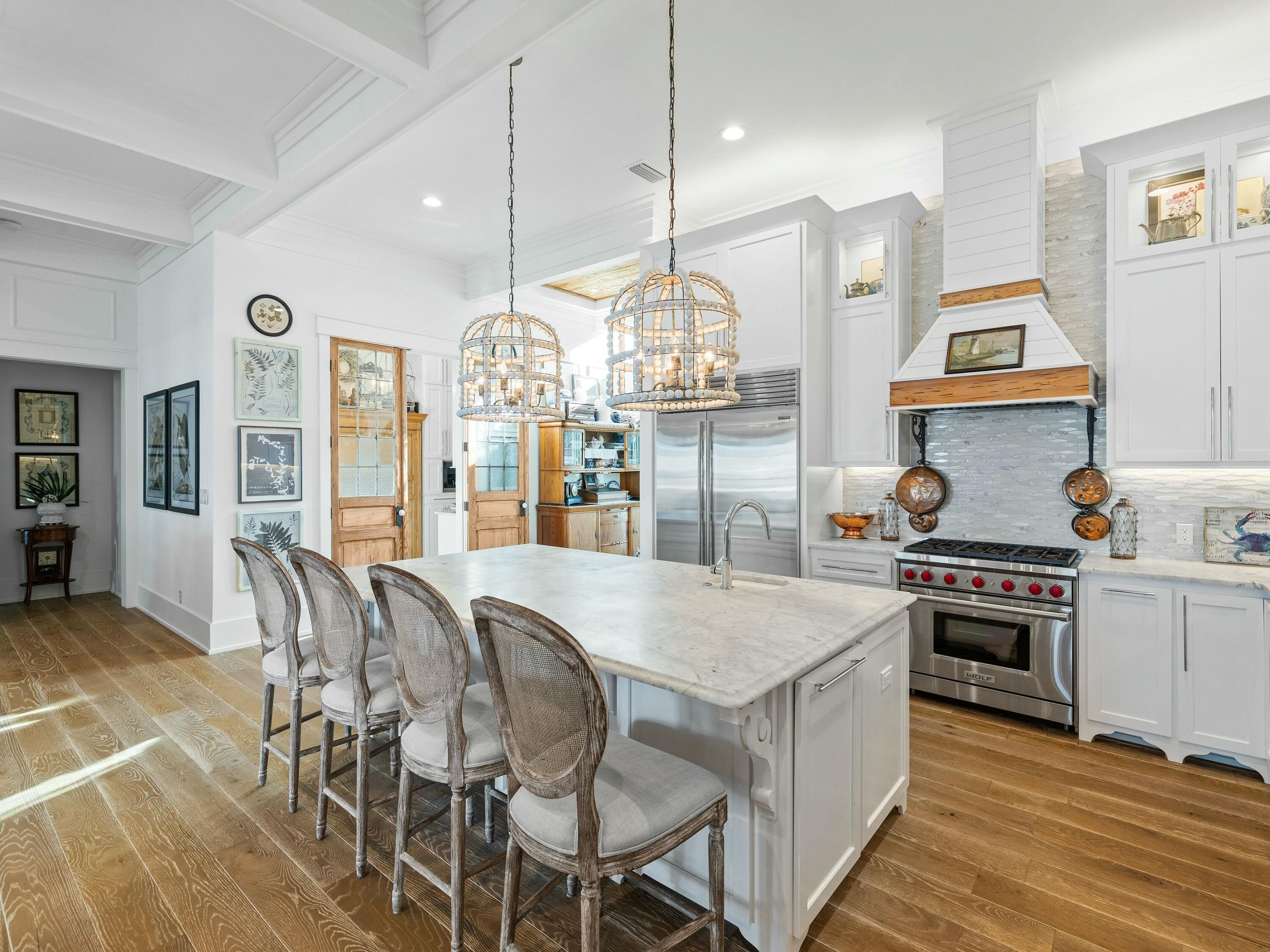 1521 Driftwood Point Road Santa Rosa Beach, FL 32459 - Photo 11 of 55 a open kitchen with stainless steel appliances granite countertop a stove top oven a sink dishwasher a dining table and chairs with wooden floor