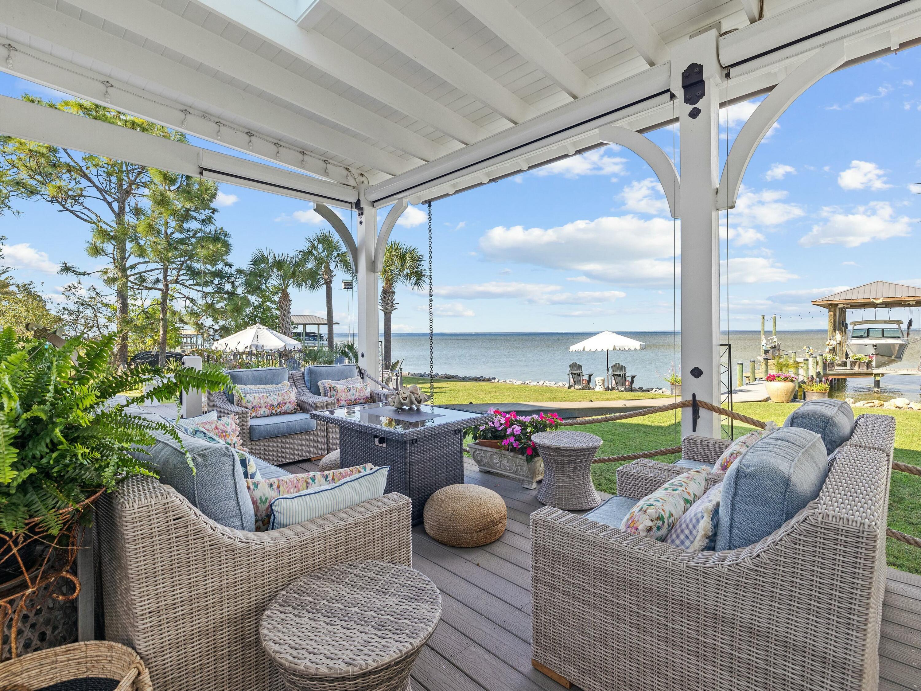 1521 Driftwood Point Road Santa Rosa Beach, FL 32459 - Photo 22 of 55 a living room with furniture and a floor to ceiling window