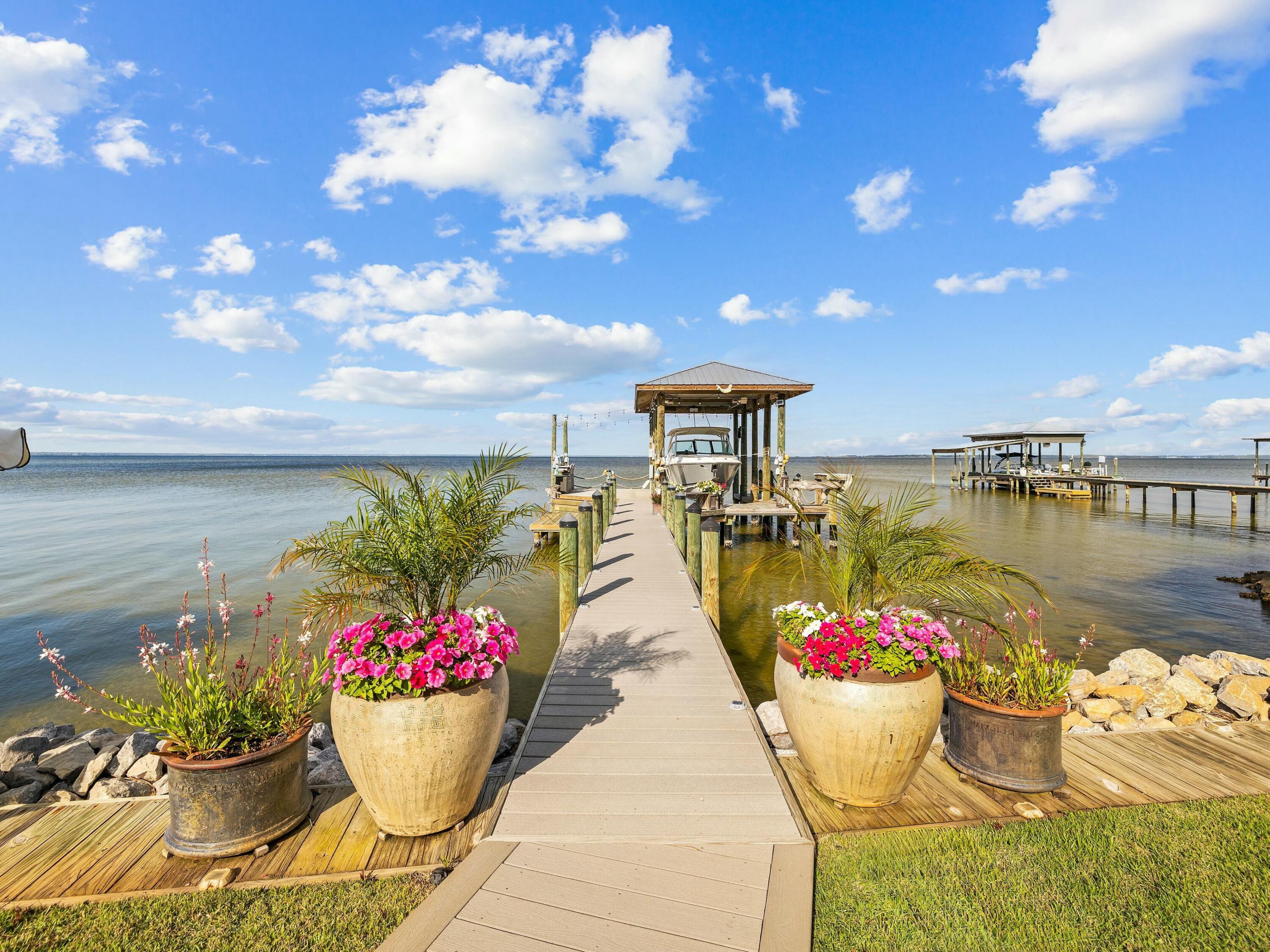 1521 Driftwood Point Road Santa Rosa Beach, FL 32459 - Photo 27 of 55 a view of a outdoor dining space with a table and chairs