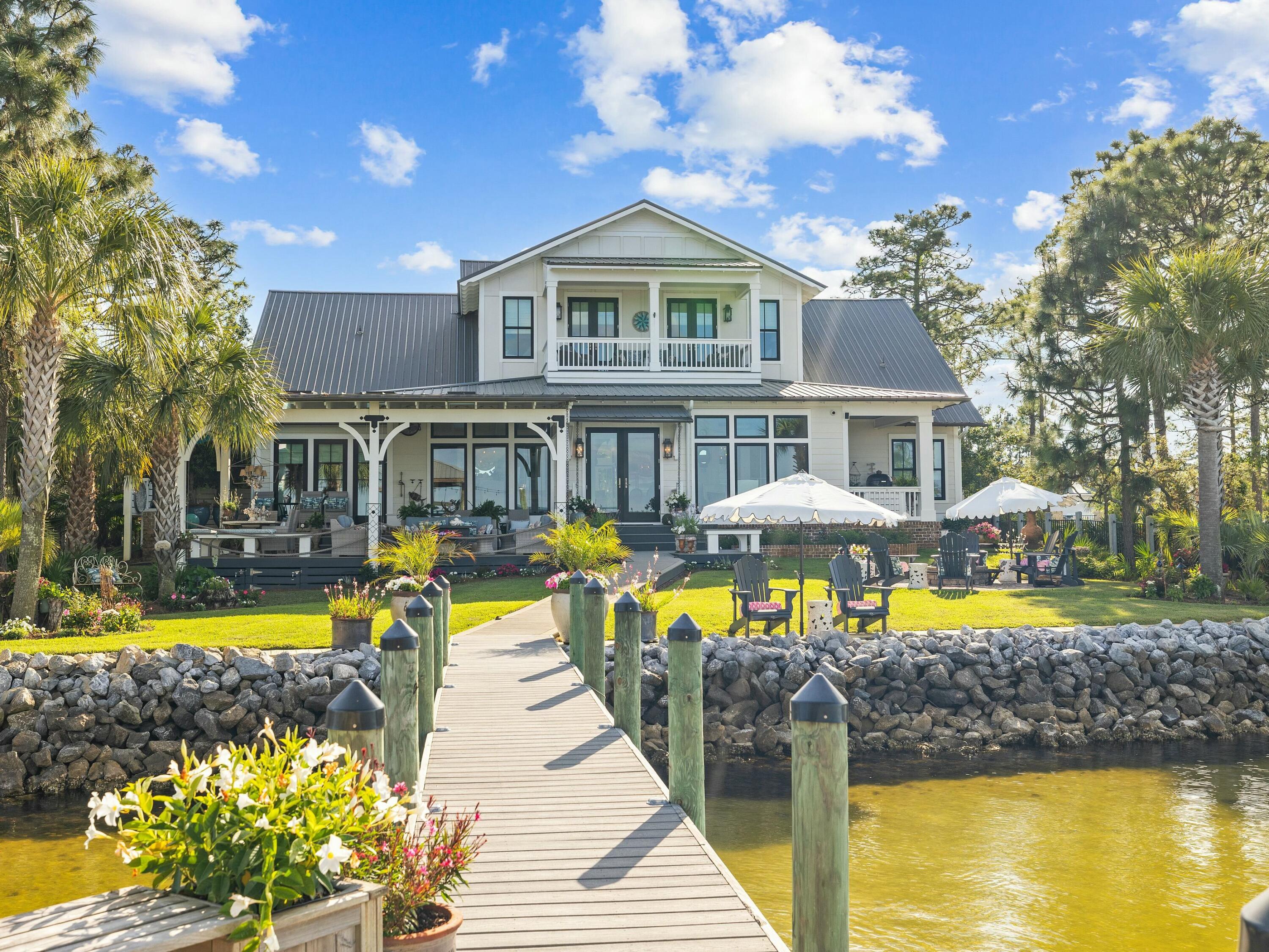 1521 Driftwood Point Road Santa Rosa Beach, FL 32459 - Photo 28 of 55 a view of a swimming pool with a lounge chairs and swimming pool