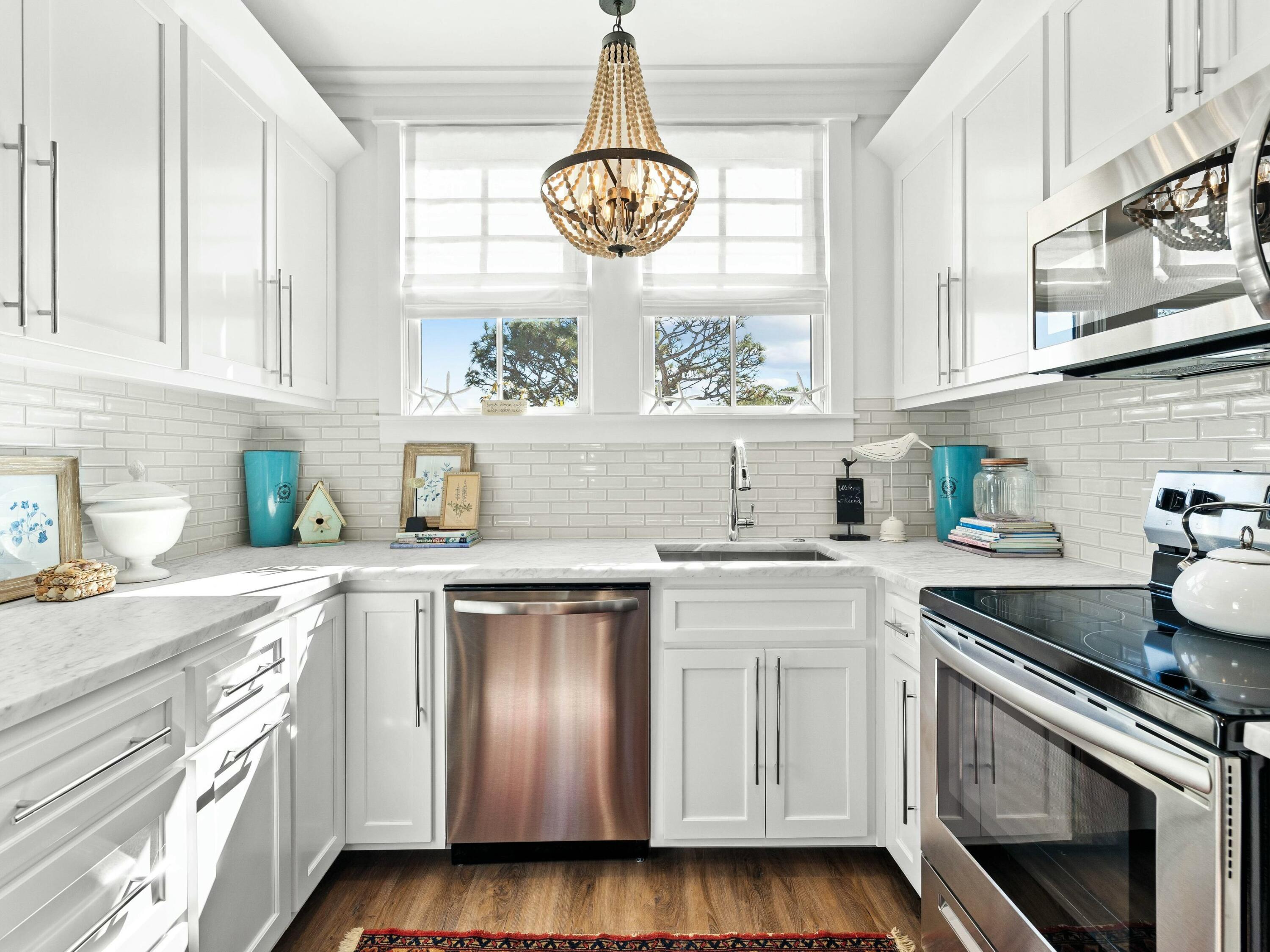 1521 Driftwood Point Road Santa Rosa Beach, FL 32459 - Photo 46 of 55 a kitchen with stainless steel appliances granite countertop white cabinets a window and a sink