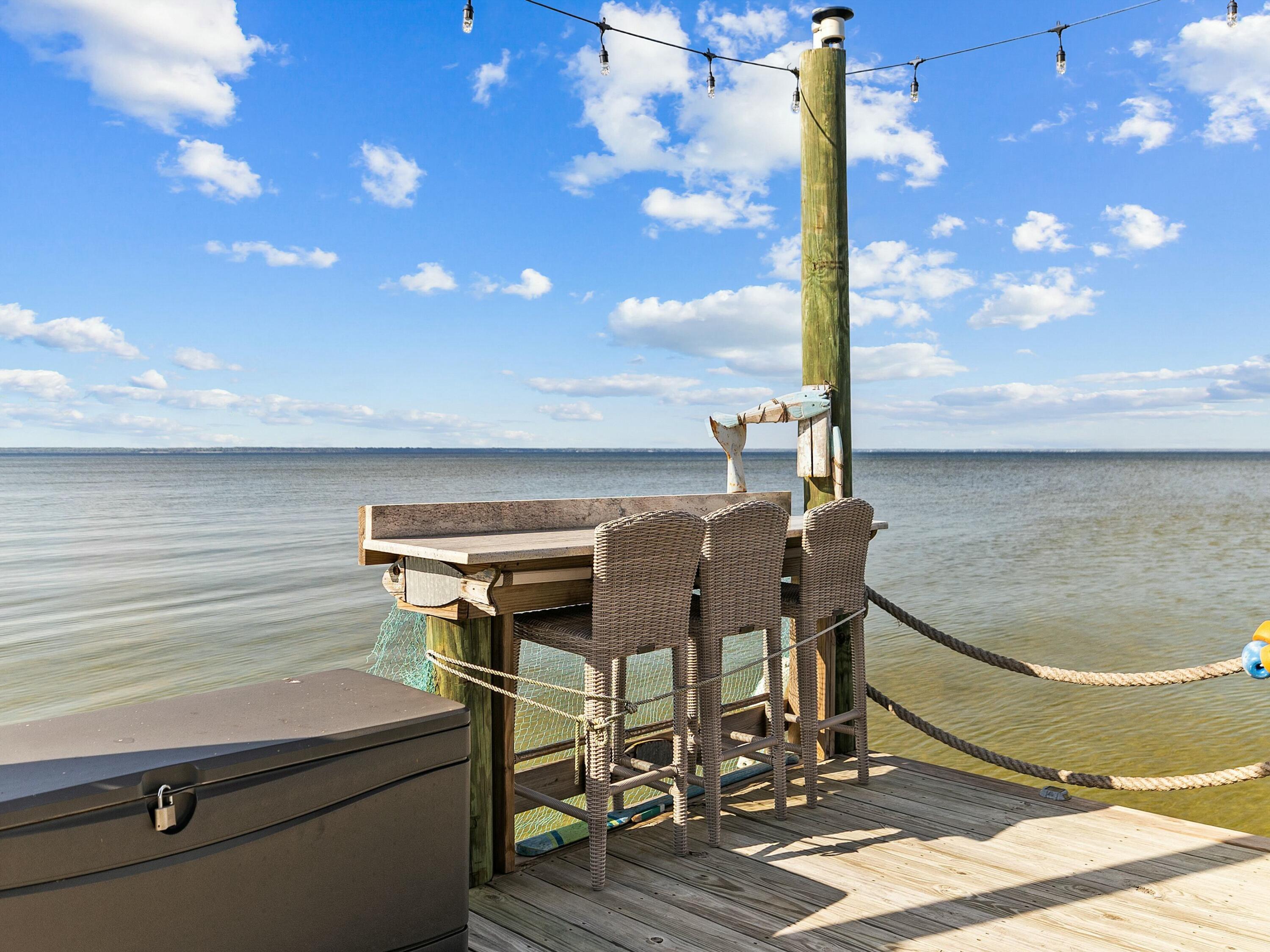 1521 Driftwood Point Road Santa Rosa Beach, FL 32459 - Photo 53 of 55 a terrace with wooden floor table and chairs