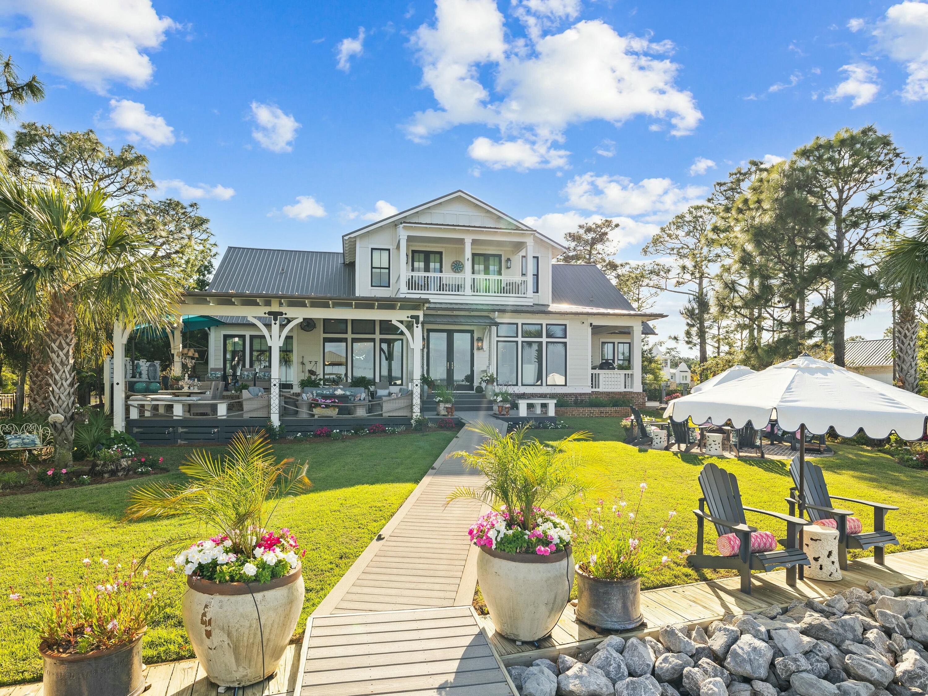 1521 Driftwood Point Road Santa Rosa Beach, FL 32459 - Photo 54 of 55 a front view of a house with swimming pool garden and patio