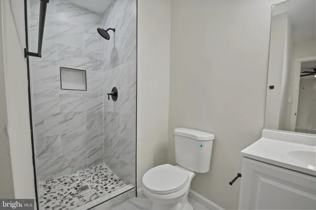 a bathroom with a toilet and a shower