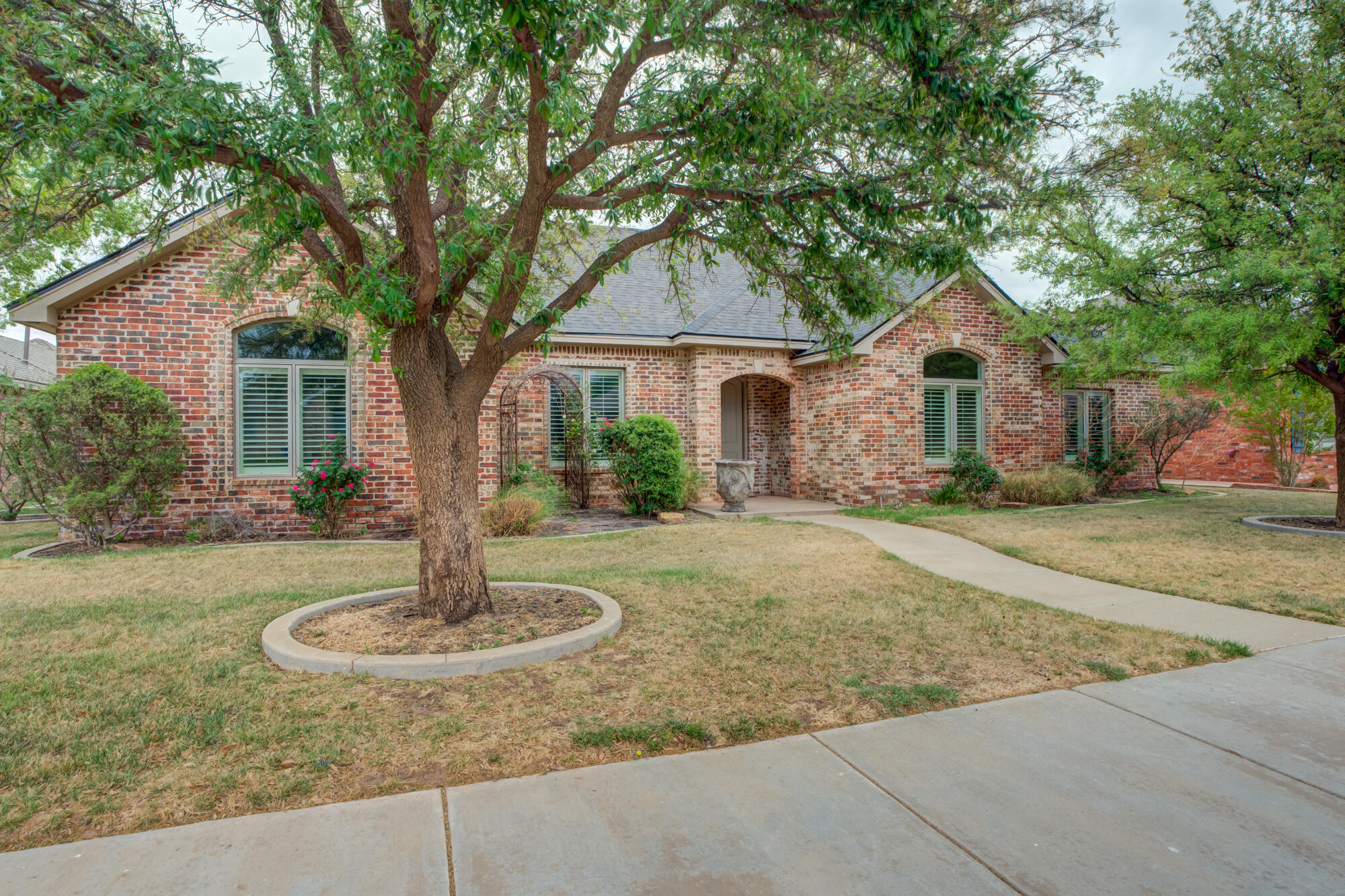 a front view of a house with a yard garage and outdoor seating