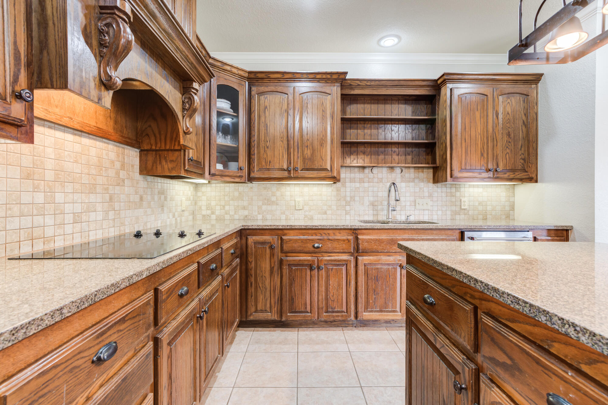 6020 85th Street Lubbock, TX 79424 - Photo 13 of 58 a kitchen with stainless steel appliances granite countertop a sink and cabinets