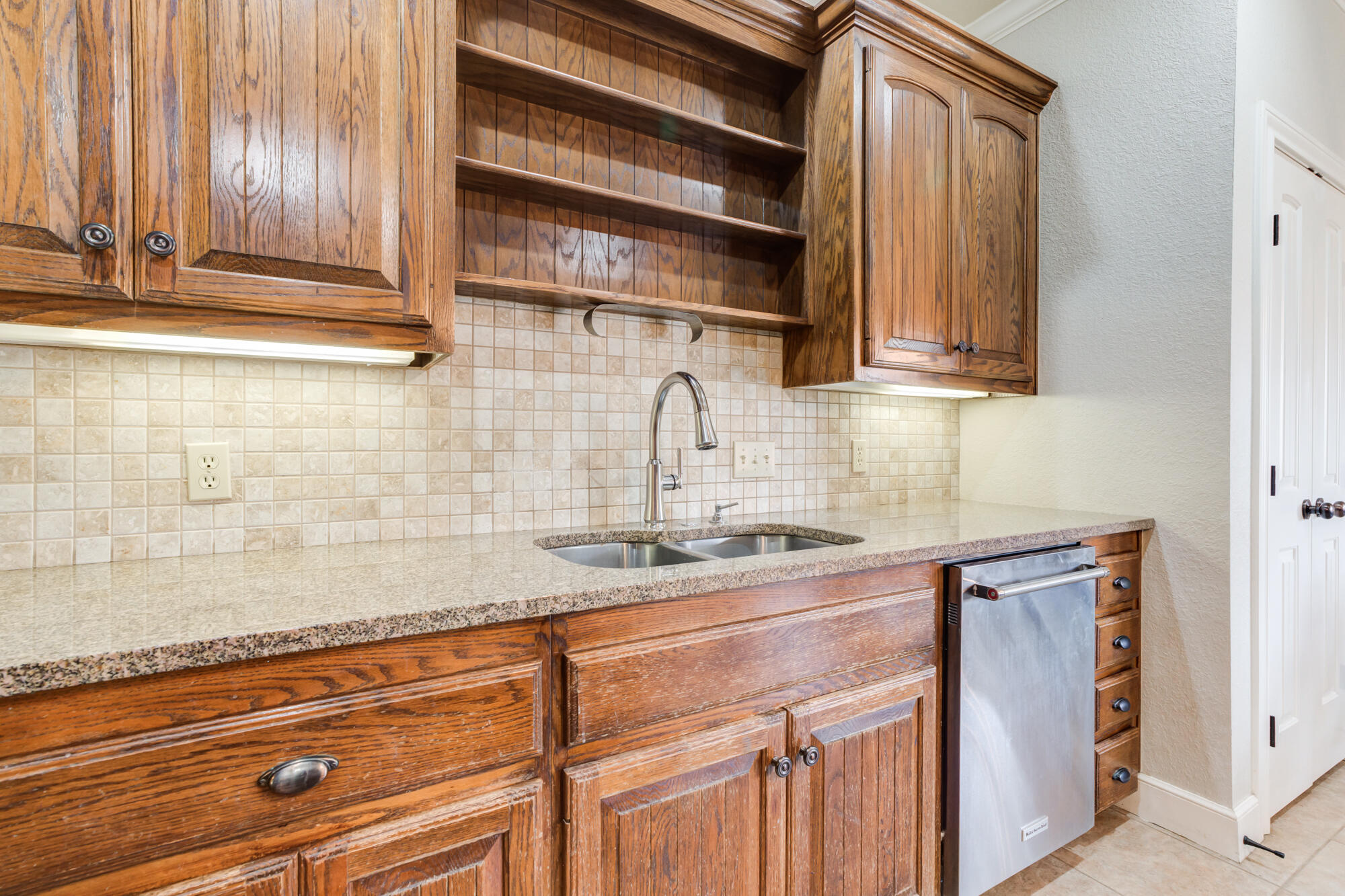 6020 85th Street Lubbock, TX 79424 - Photo 15 of 58 a kitchen with a sink and cabinets