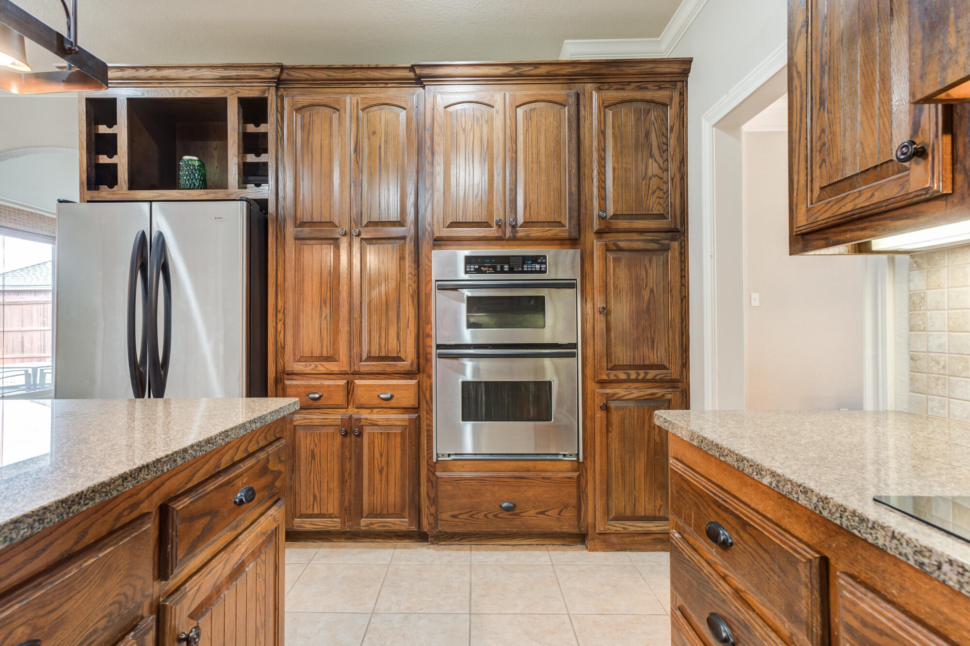 6020 85th Street Lubbock, TX 79424 - Photo 17 of 58 a kitchen with stainless steel appliances granite countertop a refrigerator and a sink