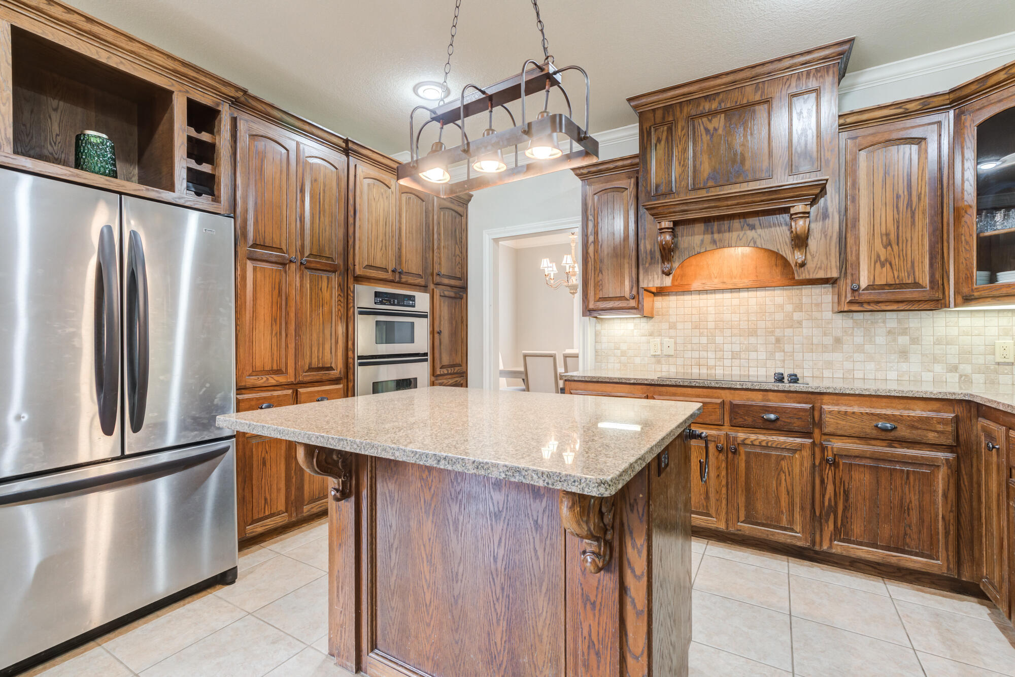 6020 85th Street Lubbock, TX 79424 - Photo 18 of 58 a kitchen with stainless steel appliances granite countertop a sink refrigerator and cabinets