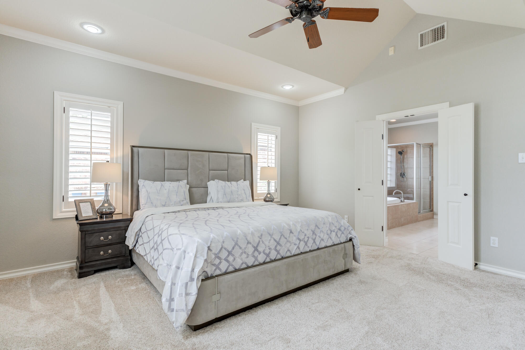 6020 85th Street Lubbock, TX 79424 - Photo 23 of 58 a spacious bedroom with a bed and painting on the wall