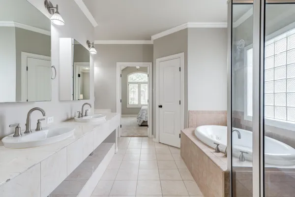 a bathroom with a double vanity sink and a mirror