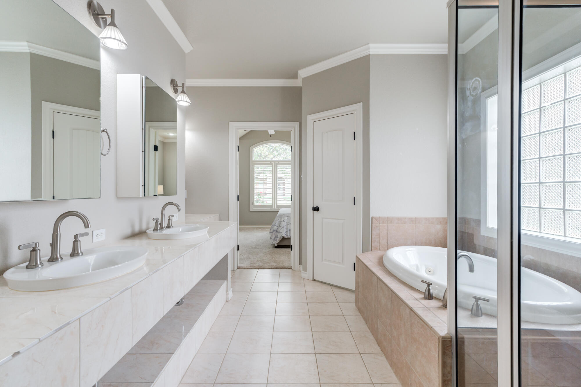 6020 85th Street Lubbock, TX 79424 - Photo 26 of 58 a bathroom with a tub sink and mirror