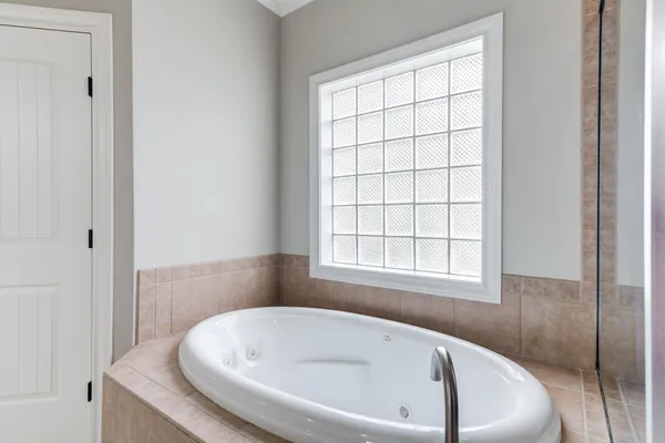 a spacious bathroom with a bathtub and a shower