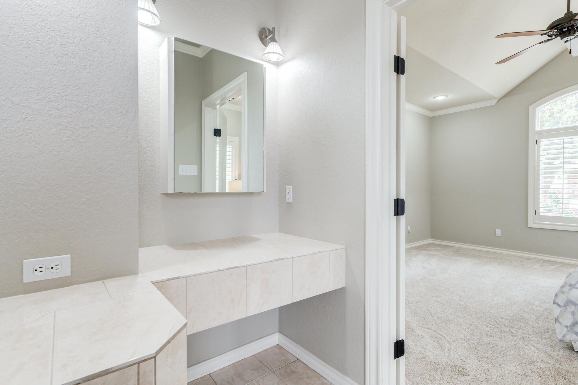 6020 85th Street Lubbock, TX 79424 - Photo 29 of 58 a bathroom with a sink a vanity and a mirror
