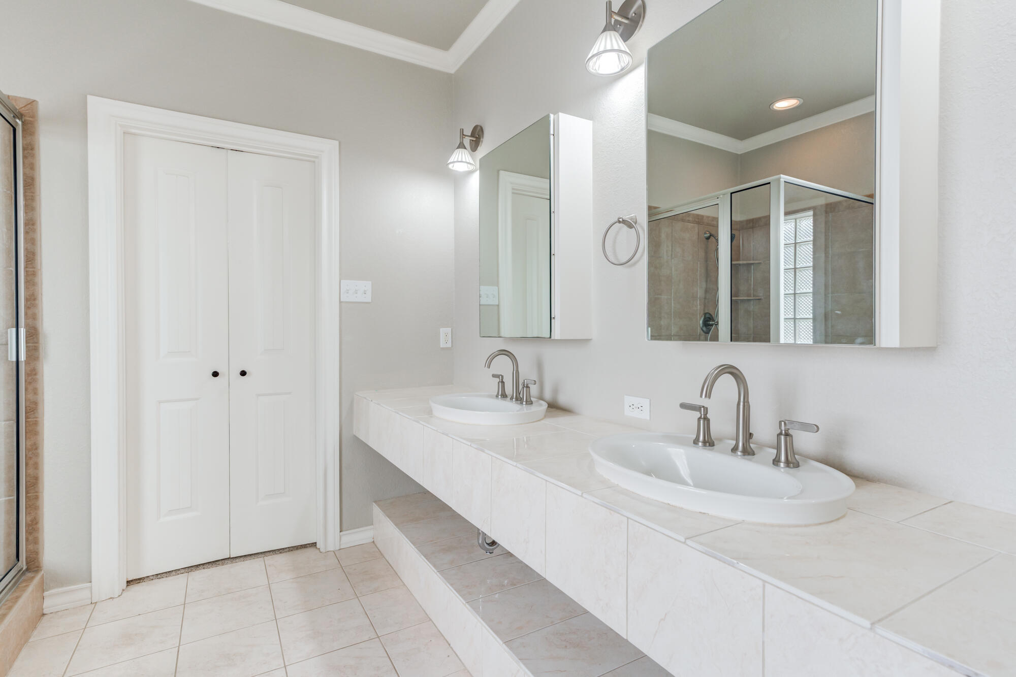 6020 85th Street Lubbock, TX 79424 - Photo 30 of 58 a bathroom with a double vanity sink and a mirror