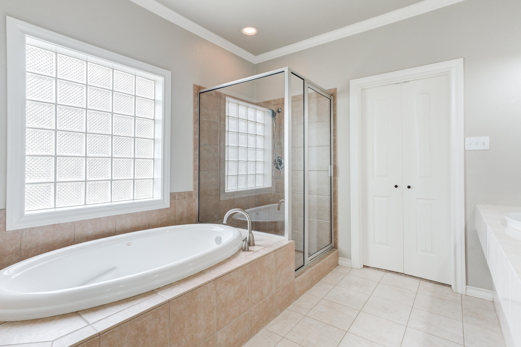 6020 85th Street Lubbock, TX 79424 - Photo 32 of 58 a spacious bathroom with a bathtub and a shower