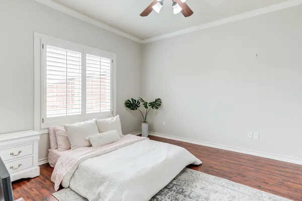 a large bed sitting in a bedroom next to a window