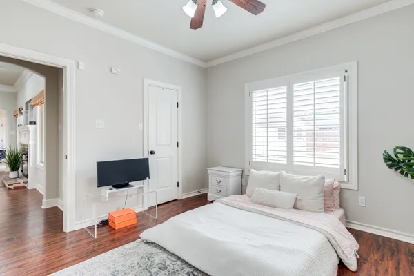 a bedroom with a bed and a night stand