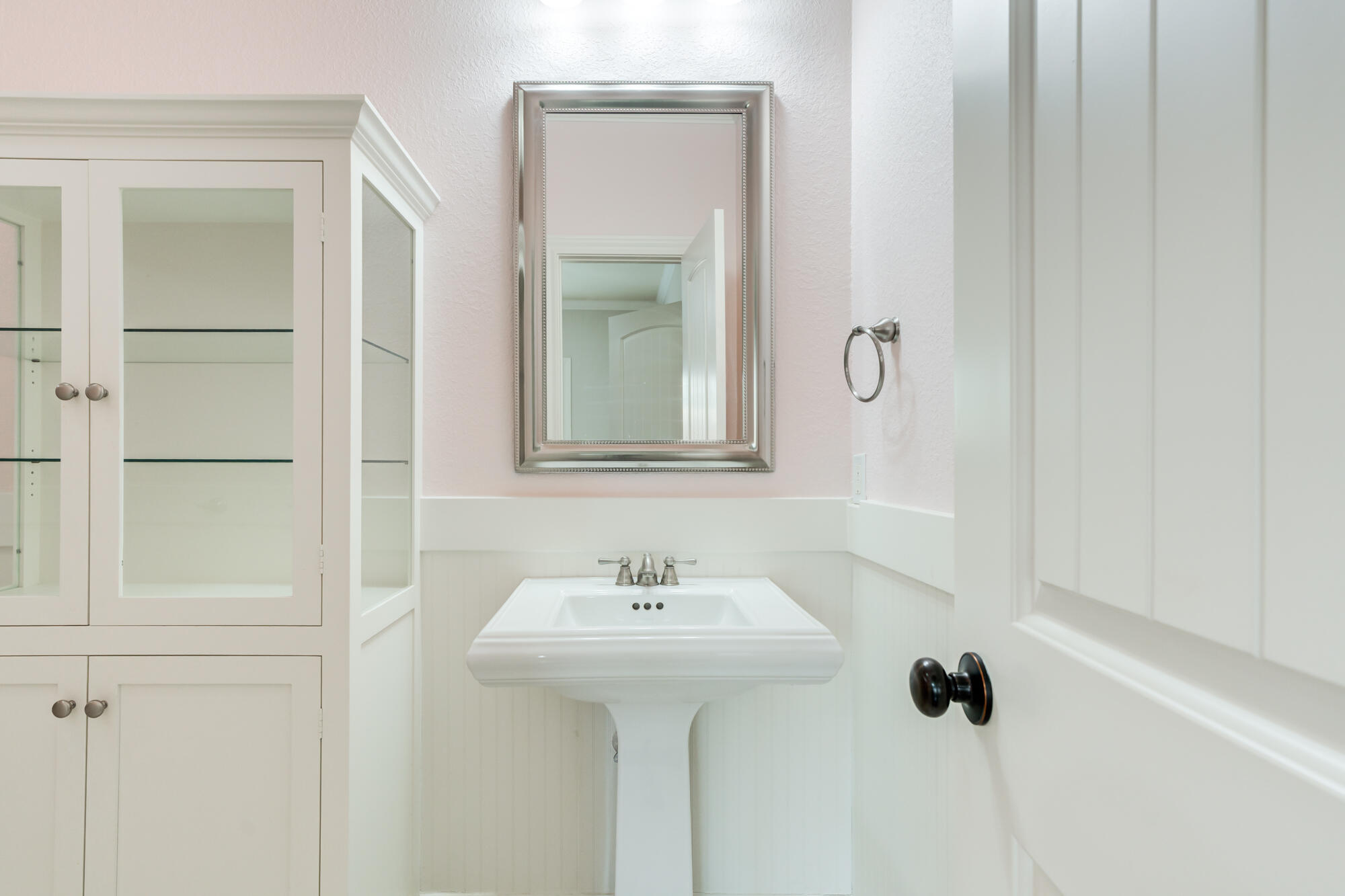 6020 85th Street Lubbock, TX 79424 - Photo 35 of 58 a bathroom with a sink and a mirror
