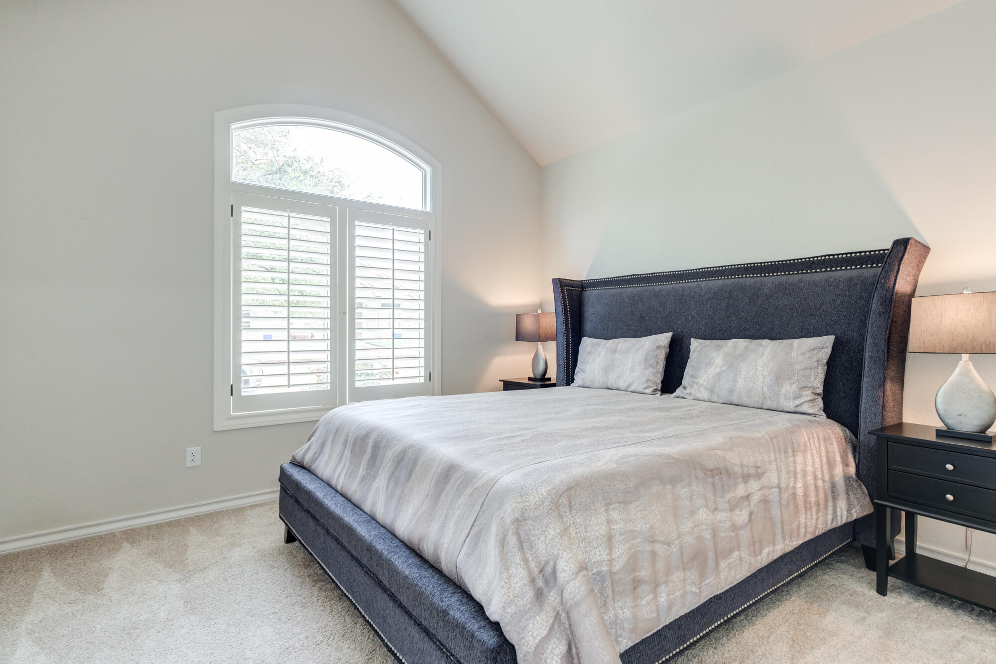 6020 85th Street Lubbock, TX 79424 - Photo 38 of 58 a large bed sitting in a bedroom next to a window