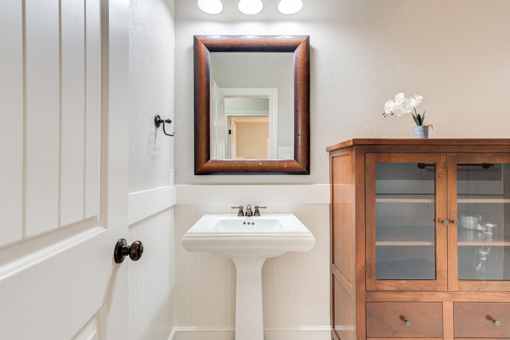 6020 85th Street Lubbock, TX 79424 - Photo 40 of 58 a bathroom with a sink and a mirror