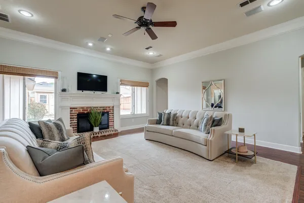 a living room with furniture a fireplace and a flat screen tv