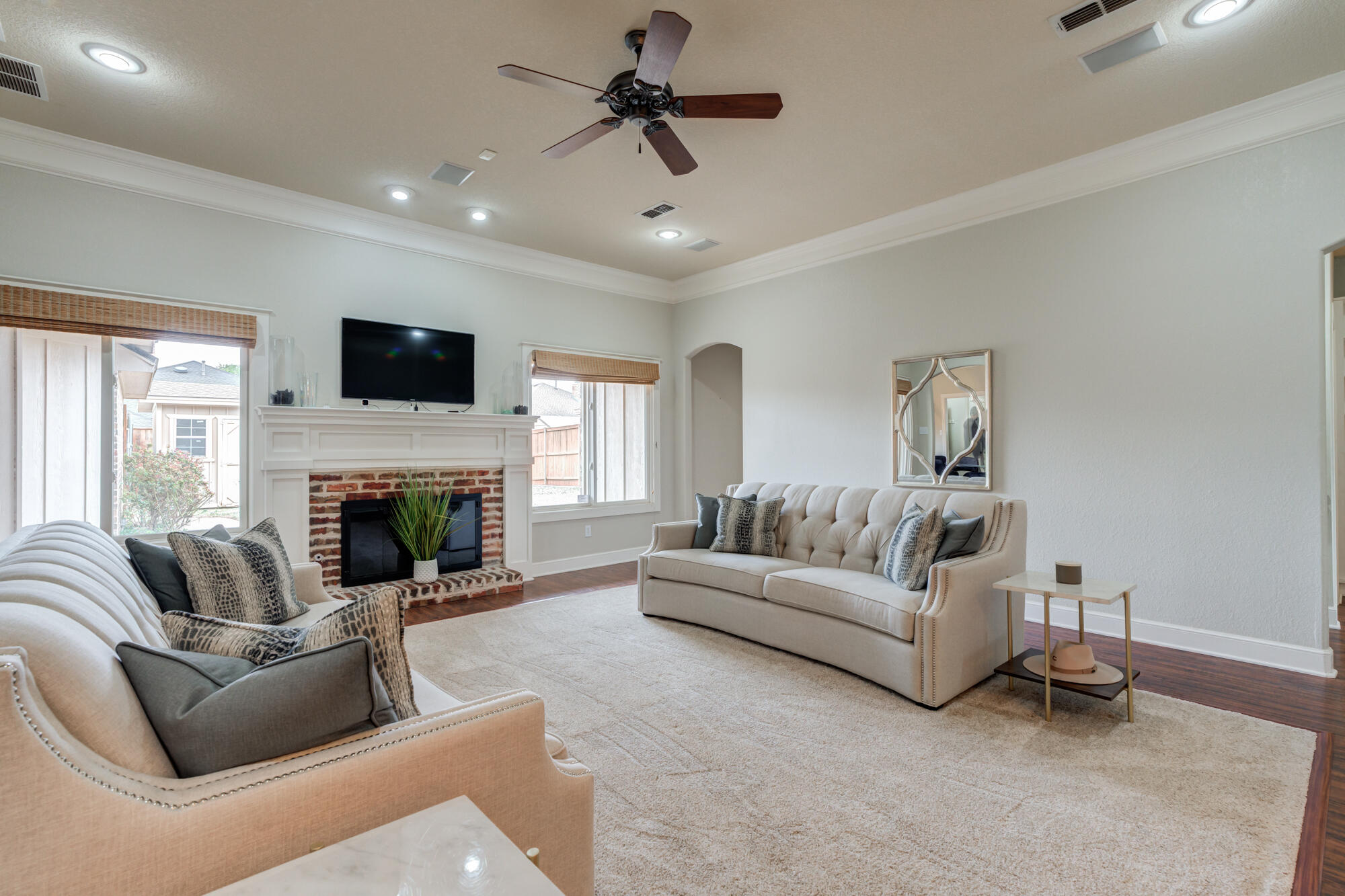 6020 85th Street Lubbock, TX 79424 - Photo 5 of 58 a living room with furniture a fireplace and a flat screen tv