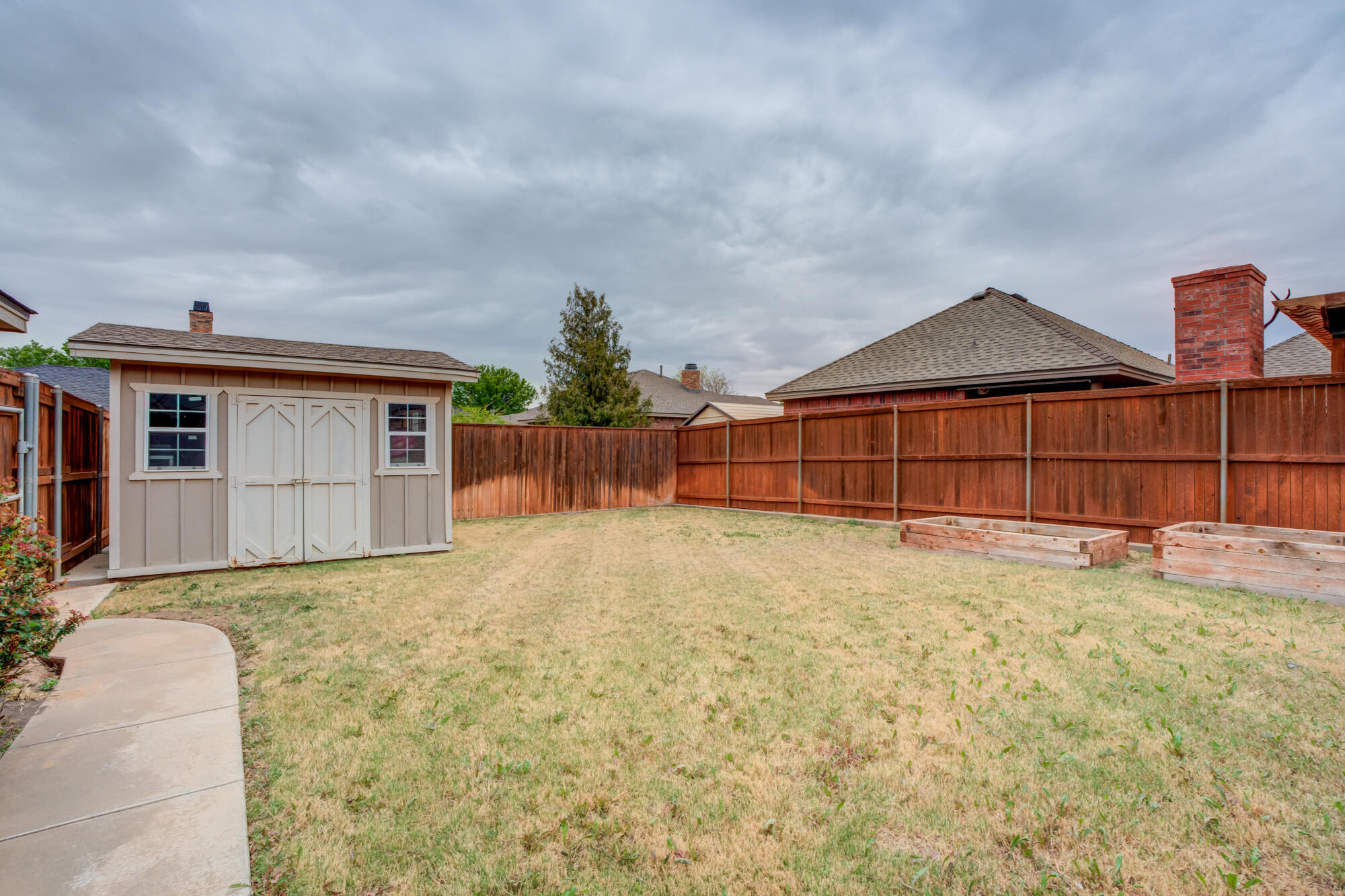 6020 85th Street Lubbock, TX 79424 - Photo 53 of 58 a front view of a house with a yard and garage