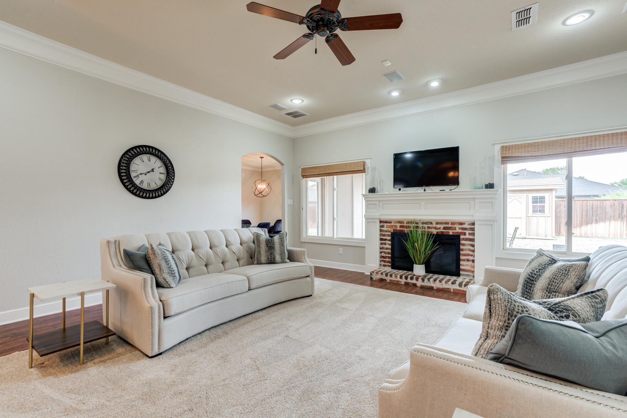 6020 85th Street Lubbock, TX 79424 - Photo 6 of 58 a living room with furniture a fireplace and a flat screen tv