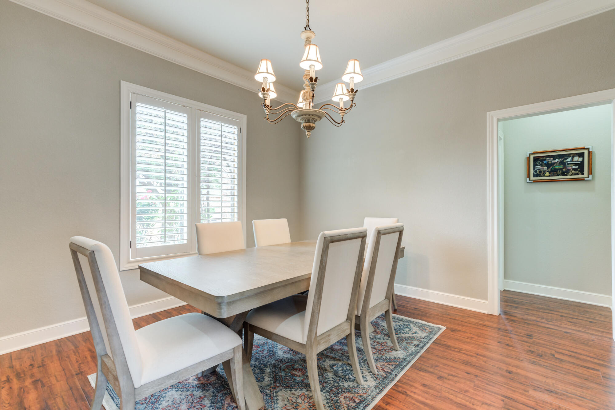 6020 85th Street Lubbock, TX 79424 - Photo 10 of 58 a view of a dining room with furniture a chandelier and wooden floor