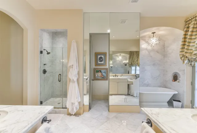 a bathroom with a granite countertop sink mirror toilet and bathtub