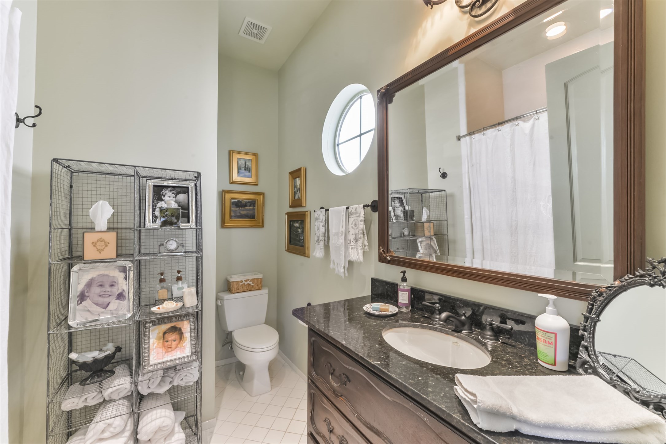 2712 Ferndale Street Houston, TX 77098 - Photo 31 of 49 a bathroom with a granite countertop toilet a sink and a mirror