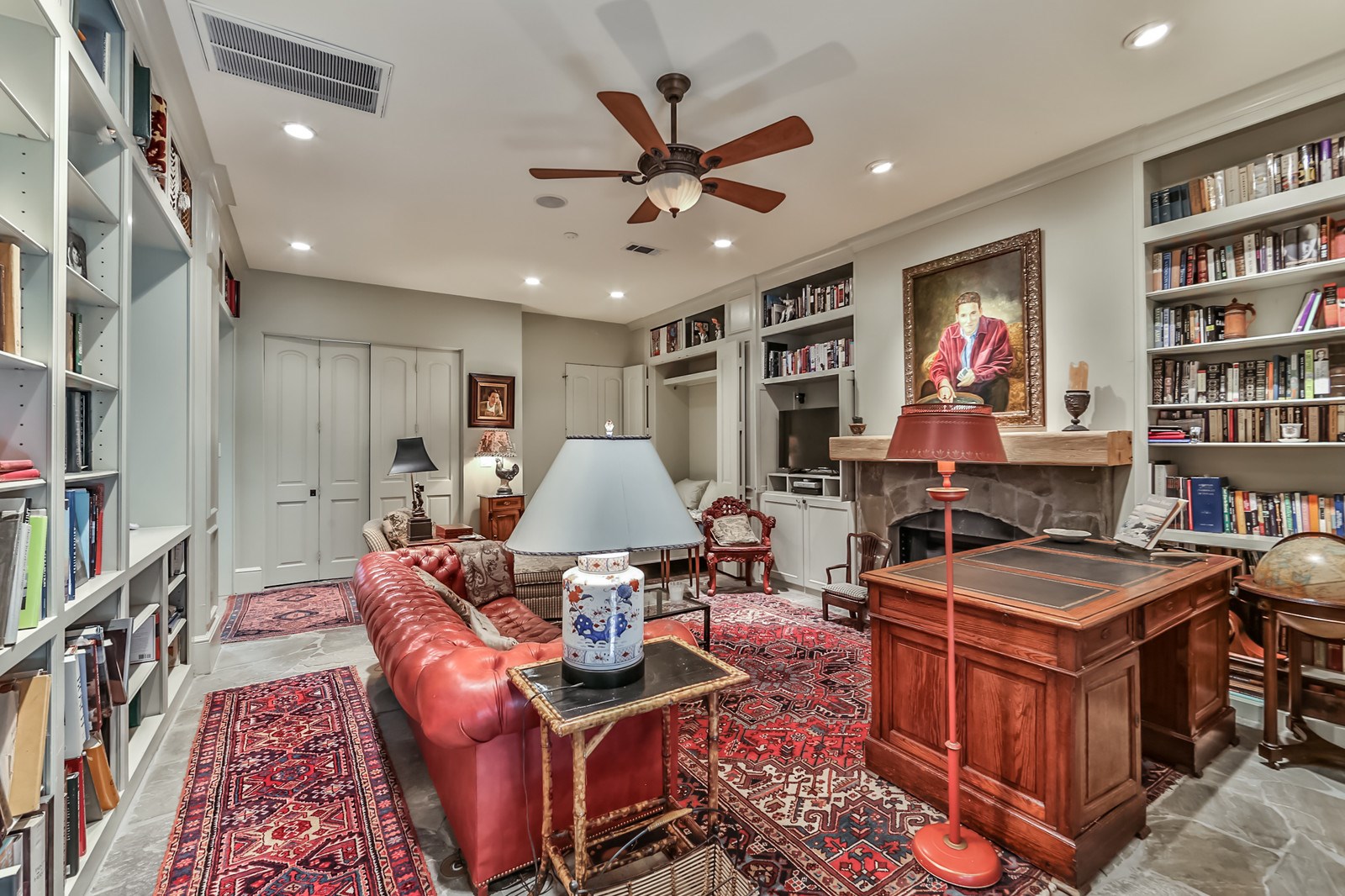 2712 Ferndale Street Houston, TX 77098 - Photo 43 of 49 a living room with fireplace furniture and a book shelf