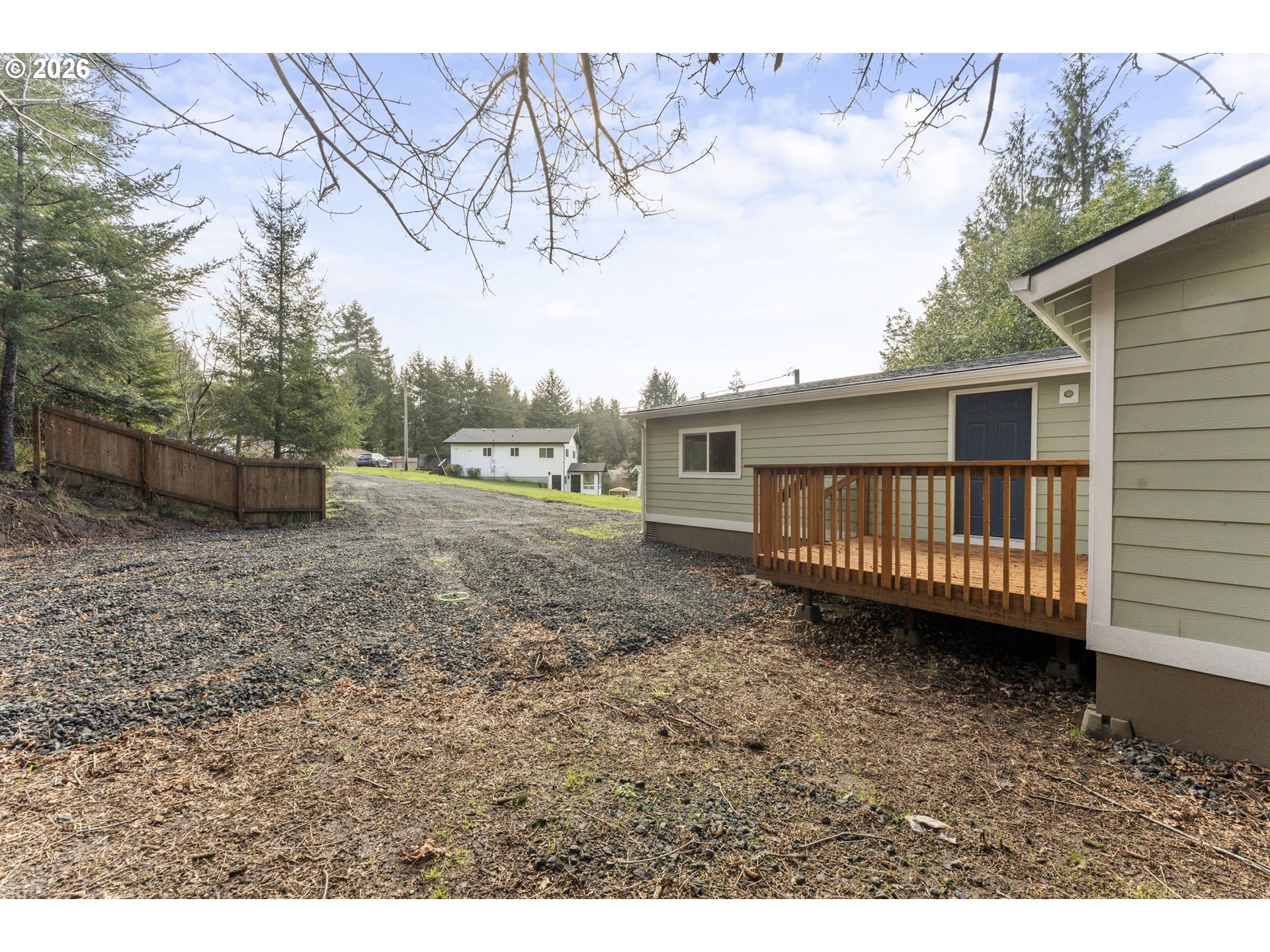 61912 Olive Barber Road Coos Bay, OR 97420 - Photo 20 of 31 a view of a house with a yard and wooden deck
