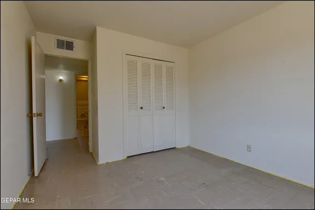 an empty room with closet area