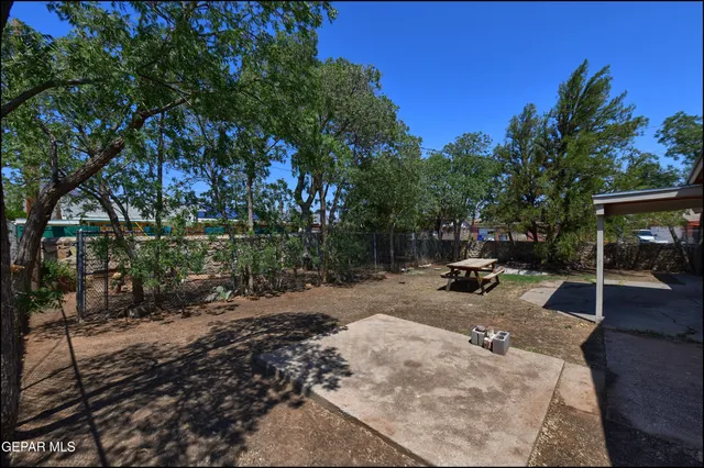 a view of a backyard with sitting area