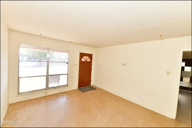 a view of an empty room with a window