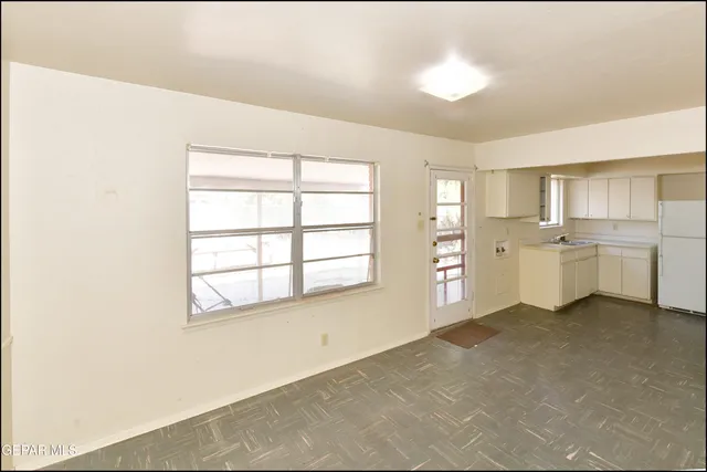 a view of a kitchen with a sink dishwasher and a refrigerator