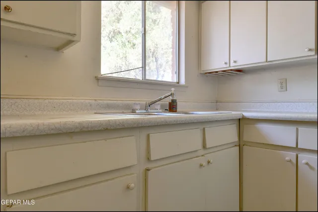 a kitchen with a sink and cabinets