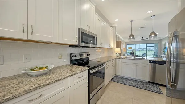 a kitchen with a sink stove and microwave