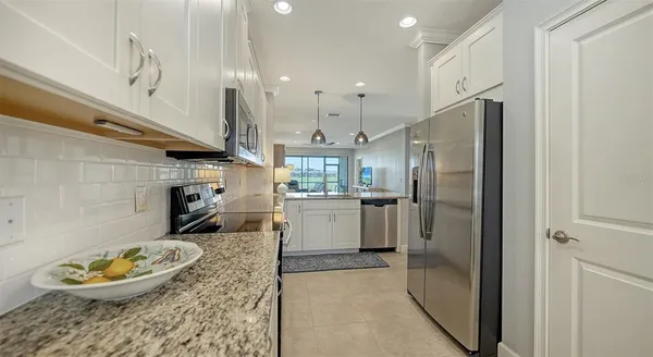 a kitchen with center island a sink stainless steel appliances and cabinets