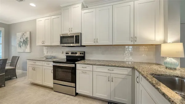 a living room with furniture a window and a flat screen tv