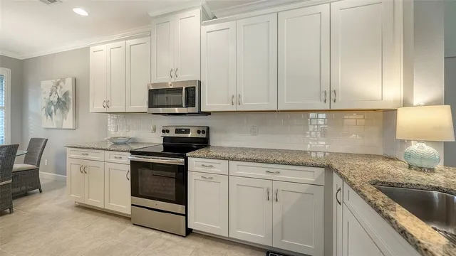 a living room with furniture a window and a flat screen tv