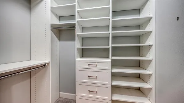 a bedroom with a bed and a lamp