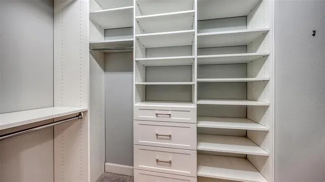 a bedroom with a bed and a lamp