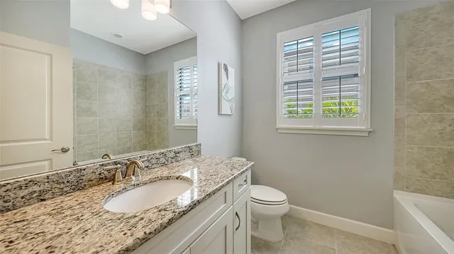 a view of a swimming pool with a lawn chairs under an umbrella